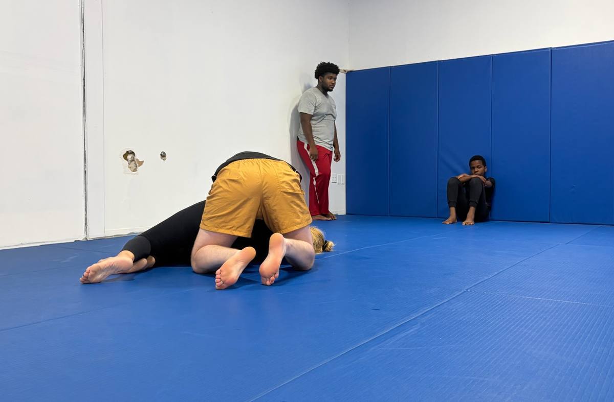 Two students training No-Gi on the mat